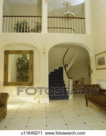 Large traditional hall with gallery landing and archway to staircase View Large Photo Image Stock Image - Large traditional hall with gallery landing and archway to staircase. Fotosearch