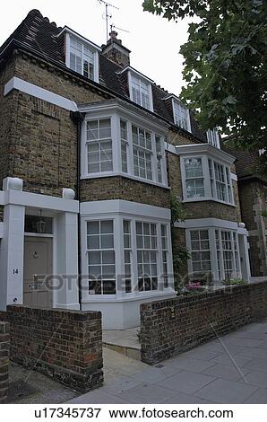 Stock Photo - Large traditional townhouse with bay windows. Fotosearch