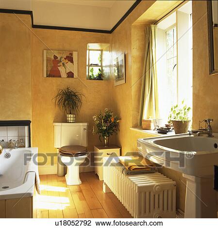 Large white radiator and wooden flooring in traditional yellow bathroom View Large Photo Image Stock Image - Large white radiator and wooden flooring in traditional yellow bathroom. Fotosearch