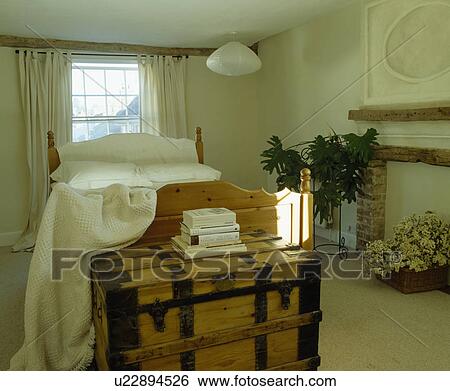 Large wooden chest below bed in cream cottage bedroom View Large Photo Image Stock Photograph - Large wooden chest below bed in cream cottage bedroom. Fotosearch