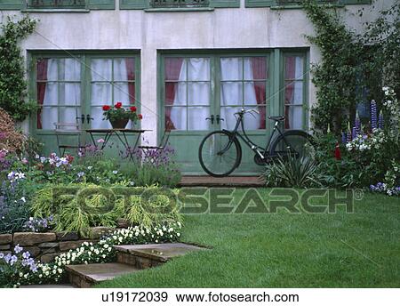 Lawn in front of house with old-fashioned bicycle leaning against green French doors View Large Photo Image Stock Photo - Lawn in front of house with old-fashioned bicycle leaning against green French doors. Fotosearch