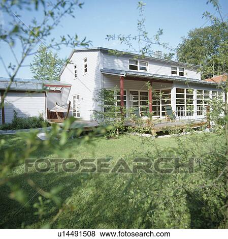 Stock Photo - Lawn in front of modern white country house. Fotosearch