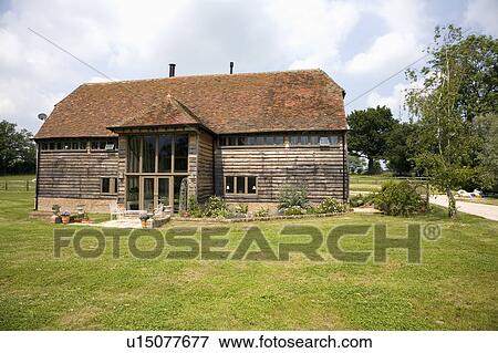 Lawn in front of traditional country barn conversion View Large Photo Image Stock Photo - Lawn in front of traditional country barn conversion. Fotosearch