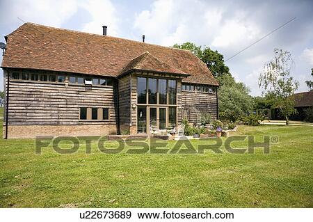 Lawn in front of traditional country barn conversion View Large Photo Image Stock Photo - Lawn in front of traditional country barn conversion. Fotosearch