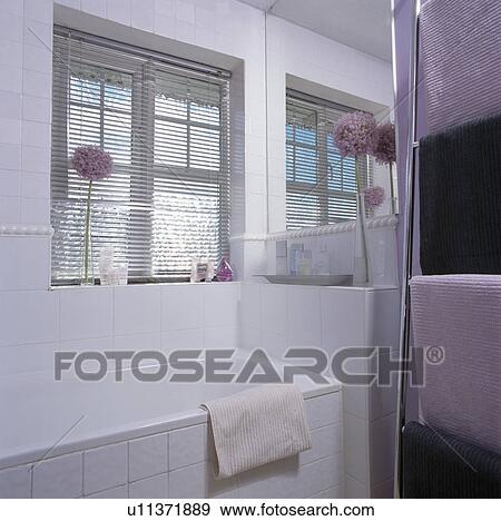 Lighted mirror above basin in built-in vanity unit in modern bathroom View Large Photo Image Stock Photo - Lighted mirror above basin in built-in vanity unit in modern bathroom. Fotosearch