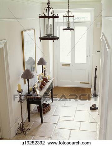 Limestone floor tiles in white hall with lantern lighting and lamps on grey console table View Large Photo Image Stock Image - Limestone floor tiles in white hall with lantern lighting and lamps on grey console table. Fotosearch