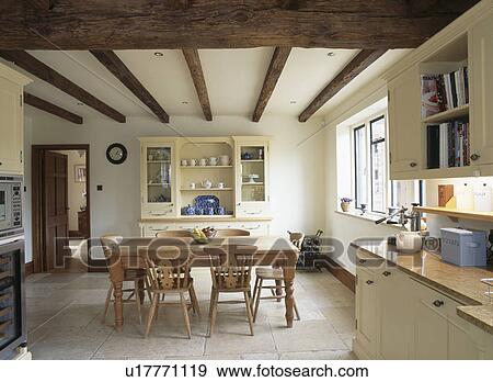 Limestone flooring in country dining room with pine table and chairs View Large Photo Image Stock Photo - Limestone flooring in country dining room with pine table and chairs. Fotosearch