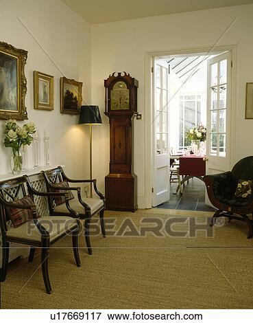 Longcase clock and cream carpet in traditional white hall View Large Photo Image Stock Photo - Longcase clock and cream carpet in traditional white hall. Fotosearch
