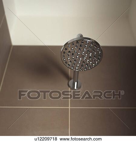Looking up at stainless steel shower head on brown wall tiles View Large Photo Image Stock Photo - Looking up at stainless steel shower head on brown wall tiles. Fotosearch