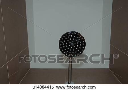 Stock Photography - Looking up at stainless steel shower head. Fotosearch