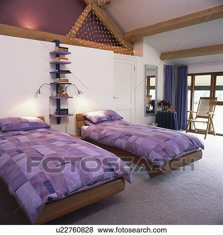 Mauve duvets on twin beds in modern attice bedroom View Large Photo Image Stock Photo - Mauve duvets on twin beds in modern attice bedroom. Fotosearch