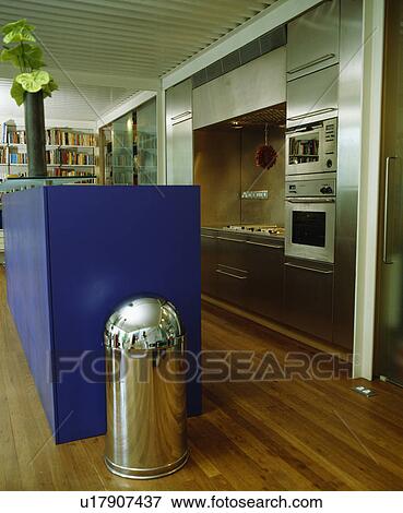 Metal pedestal bin in modern stainless steel kitchen with blue island unit View Large Photo Image Stock Photo - Metal pedestal bin in modern stainless steel kitchen with blue island unit. Fotosearch