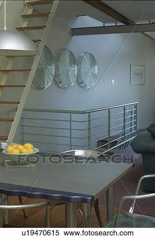Metal table in modern loft conversion dining room View Large Photo Image Stock Photography - Metal table in modern loft conversion dining room. Fotosearch