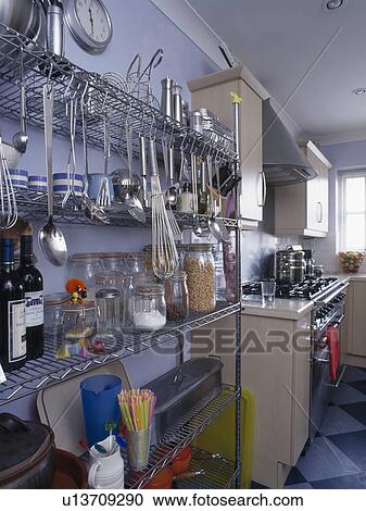 Metal utensils on stainless steel storage racks in pastel blue kitchen View Large Photo Image Stock Image - Metal utensils on stainless steel storage racks in pastel blue kitchen. Fotosearch