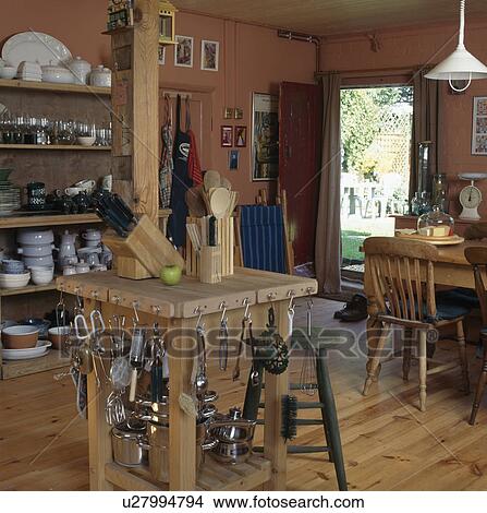 Picture - Metal utensils stored on butcher's block in country kitchen. Fotosearch