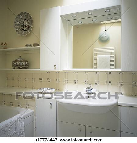 Mirror above basin in modern bathroom with floral tiles View Large Photo Image Stock Photo - Mirror above basin in modern bathroom with floral tiles. Fotosearch