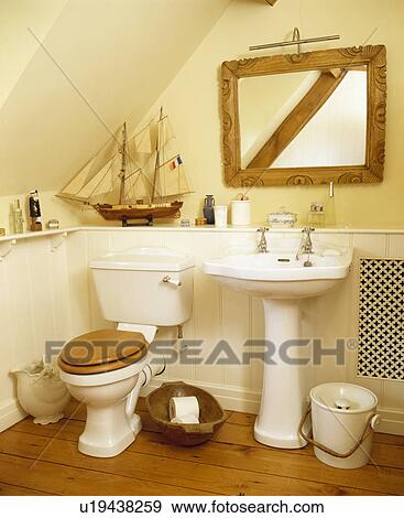 Model Sailing Boat And Wooden Mirror Above White Pedestal Basin In Cottage Bathroom Stock Photo U19438259 Fotosearch