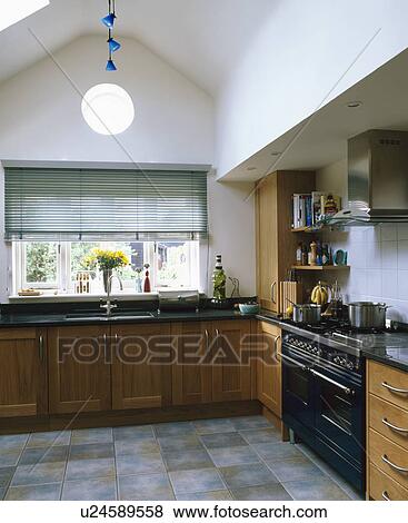 Stock Photo - Modern kitchen extension with range oven and apex ceiling. Fotosearch