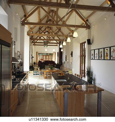 Modern Kitchen In Large Open Plan Barn Conversion Stock Image