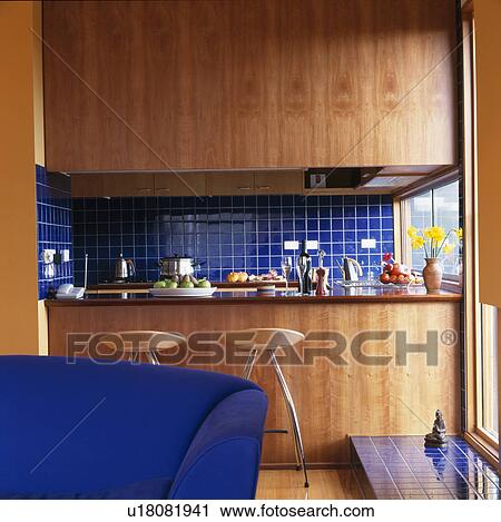 Modern kitchen with wood panelling and blue wall tiles View Large Photo Image Stock Image - Modern kitchen with wood panelling and blue wall tiles. Fotosearch