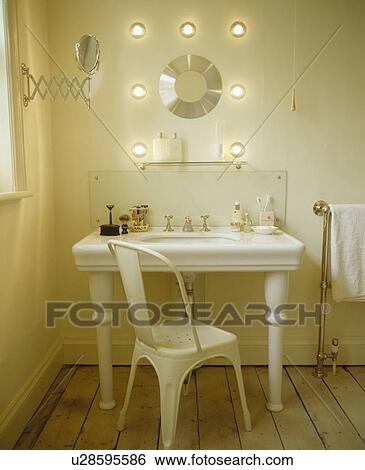 Modern white chair and large white porcelain basin below modern wall lights View Large Photo Image Stock Photograph - Modern white chair and large white porcelain basin below modern wall lights. Fotosearch