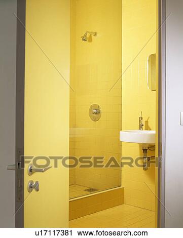 Stock Image - Modern yellow shower room. Fotosearch