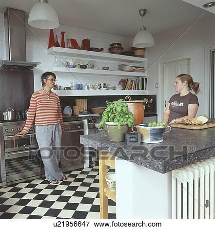 Mother and daughter in modern kitchen View Large Photo Image Stock Photo - Mother and daughter in modern kitchen. Fotosearch