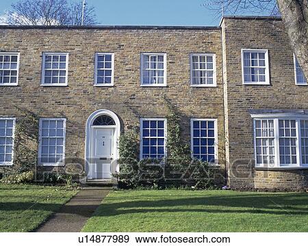 Stock Photo - New-build double-fronted traditional town-house. Fotosearch