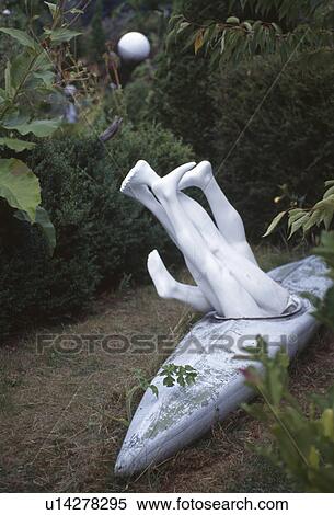 Stock Photography - Novelty sculpture of old kayak and shop mannequins. Fotosearch