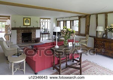 Oak gate-leg table behind red sofa in country living room View Large Photo Image Stock Image - Oak gate-leg table behind red sofa in country living room. Fotosearch