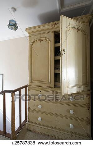 Stock Photo - Old cream painted linen press on landing. Fotosearch