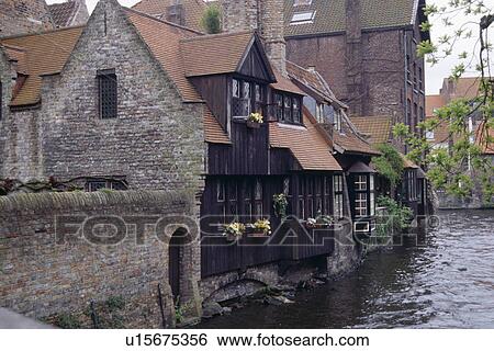 Old house backing onto river in small village View Large Photo Image Stock Photograph - Old house backing onto river in small village. Fotosearch