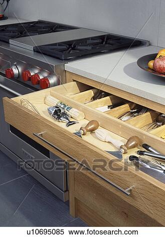 Open cutlery storage drawer below stone composite worktop View Large Photo Image Stock Photography - Open cutlery storage drawer below stone composite worktop. Fotosearch
