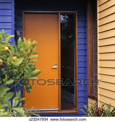 Orange door in modern blue house with one yellow wall View Large Photo Image Picture - Orange door in modern blue house with one yellow wall. Fotosearch