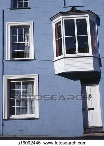 Stock Photograph - Oriel window in small blue traditional terraced house. Fotosearch