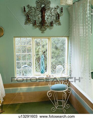 Ornate metal wall sconce above window of turquoise landing View Large Photo Image Stock Image - Ornate metal wall sconce above window of turquoise landing. Fotosearch