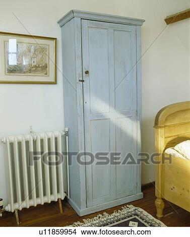 Painted blue wardrobe and radiator in pastel blue bedroom View Large Photo Image Picture - Painted blue wardrobe and radiator in pastel blue bedroom. Fotosearch
