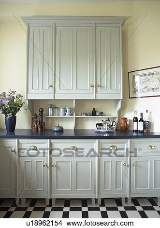 Pale grey fitted cupboard and units in traditional kitchen View Large Photo Image Picture - Pale grey fitted cupboard and units in traditional kitchen. Fotosearch
