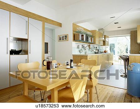 Pale wood table and chairs in modern openplan kitchen dining room View Large Photo Image Stock Image - Pale wood table and chairs in modern openplan kitchen dining room. Fotosearch