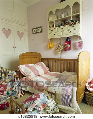 Pastel patchwork quilt on small cot-bed in child's bedroom View Large Photo Image Stock Photo - Pastel patchwork quilt on small cot-bed in child's bedroom. Fotosearch