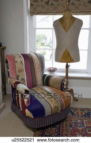 Patchwork upholstered armchair and tailor's dummy in front of sash window View Large Photo Image Stock Image - Patchwork upholstered armchair and tailor's dummy in front of sash window. Fotosearch