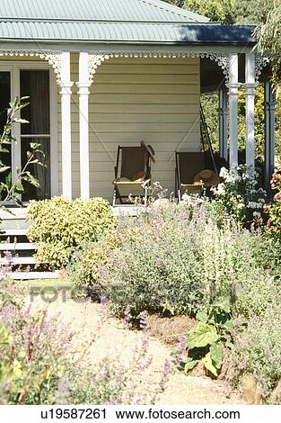 Path through herb borders to veranda on traditional country house View Large Photo Image Stock Image - Path through herb borders to veranda on traditional country house. Fotosearch