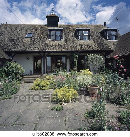 Paved area in front of singe-storey country house with dormer windowsl View Large Photo Image Stock Photo - Paved area in front of singe-storey country house with dormer windowsl. Fotosearch