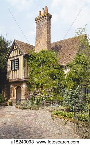 Paved driveway to timbered house covered with green climber and with tall chimney View Large Photo Image Stock Image - Paved driveway to timbered house covered with green climber and with tall chimney. Fotosearch