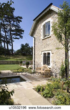 Paved path and patio in front of stone country house View Large Photo Image Stock Photograph - Paved path and patio in front of stone country house. Fotosearch