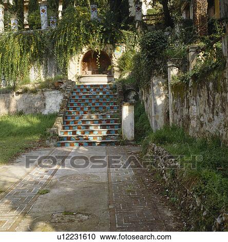 Paved path to ceramic tiled steps in sunken wall garden View Large Photo Image Stock Image - Paved path to ceramic tiled steps in sunken wall garden. Fotosearch