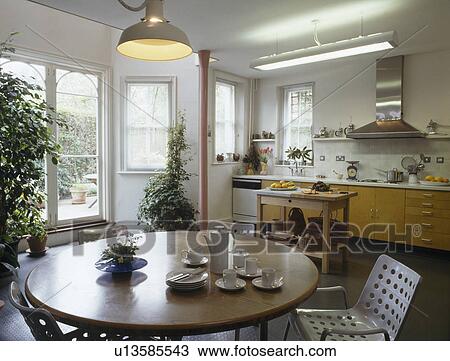 Pendant light above circular table in modern kiitchen dining room View Large Photo Image Stock Image - Pendant light above circular table in modern kiitchen dining room. Fotosearch