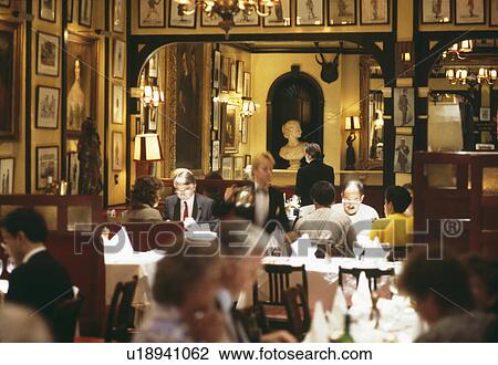 Stock Image - People dining at traditional restaurant in London. Fotosearch