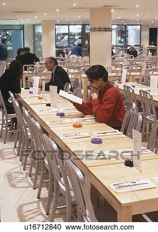 Stock Image - People dining in modern London restaurant. Fotosearch