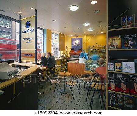Picture - People sitting in colourful cafe. Fotosearch